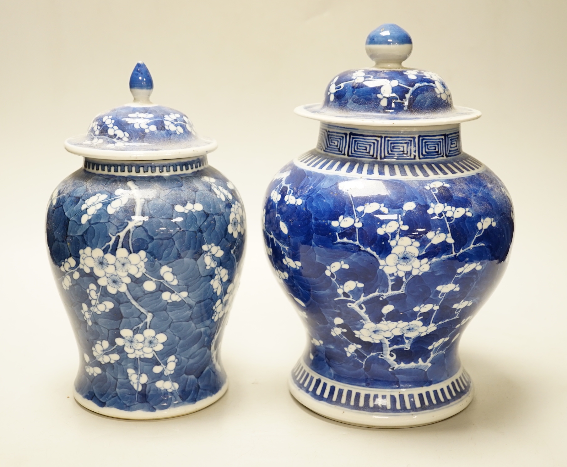 Two late 19th century Chinese blue and white prunus pattern vases, tallest 28cm high (a.f.)